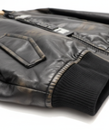 Professional close-up detail shot of black leather bomber jacket